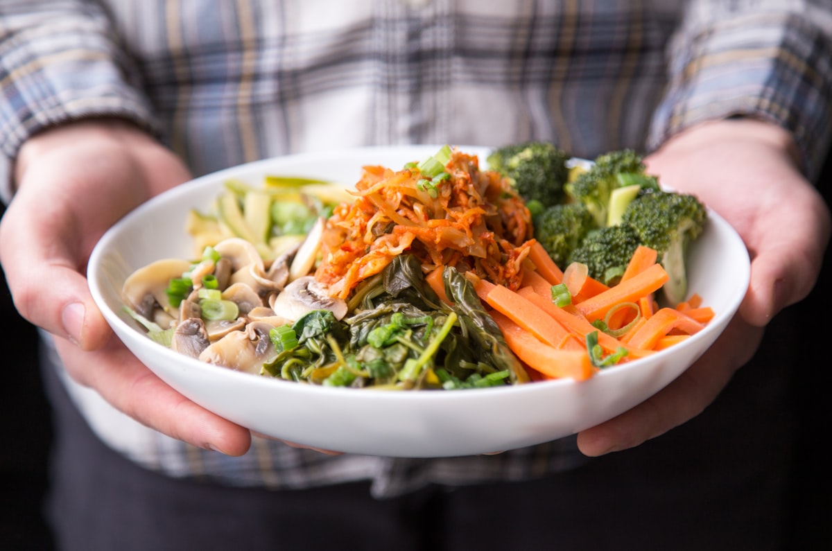 Fresh plant-based ingredients including vegetables, legumes, and whole grains
